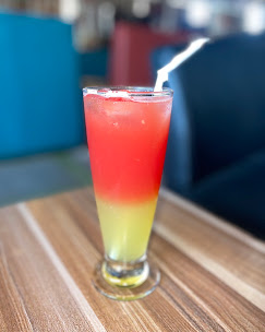 Layered red and yellow fruit punch in a tall glass