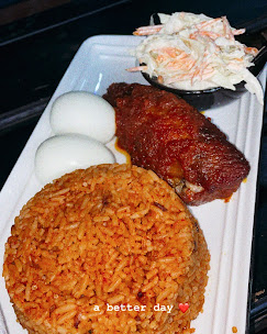 Jollof rice with chicken, eggs and coleslaw takeaway plate